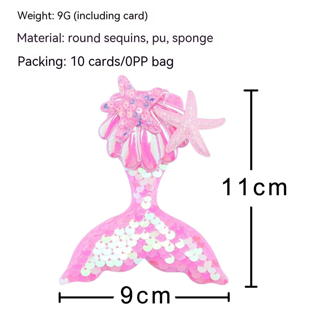 Colorful mermaid tail barrettes displayed on a table, featuring starfish designs and shimmering sequins for girls' hair.