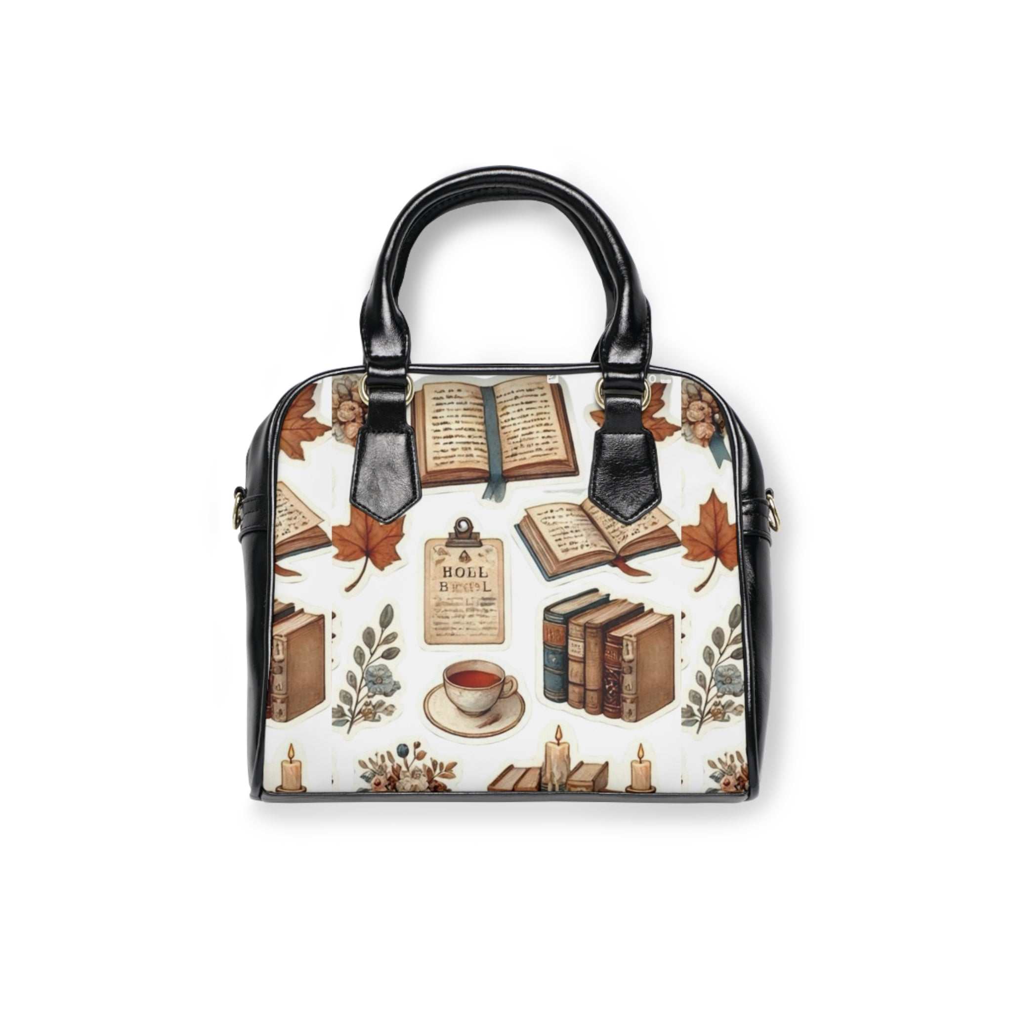 Black-handled shoulder handbag with book and autumn leaf print, removable adjustable strap, and zippered top closure.