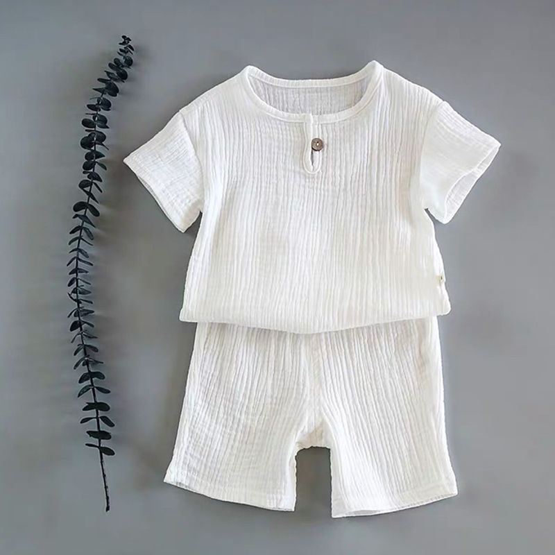 Baby short-sleeved summer outfit in earthy tones hanging on hooks, perfect for warm weather comfort.