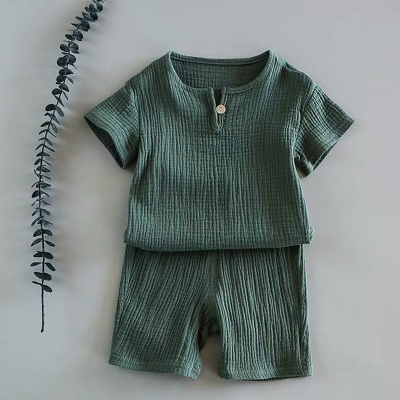 Baby short-sleeved summer outfit in earthy tones hanging on hooks, perfect for warm weather comfort.