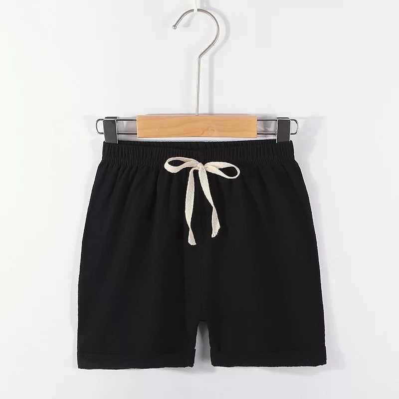Children's cotton shorts in light blue, yellow, and orange for summer outings.