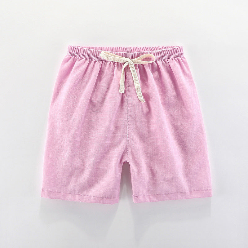 Children's cotton shorts in light blue, yellow, and orange for summer outings.