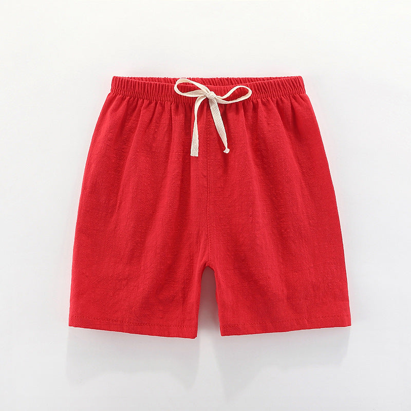 Children's cotton shorts in light blue, yellow, and orange for summer outings.